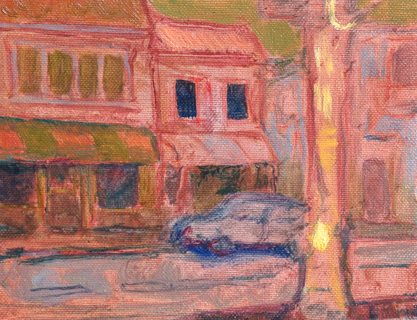 A street with pink buildings, a parked car and a vertical yellow line.
